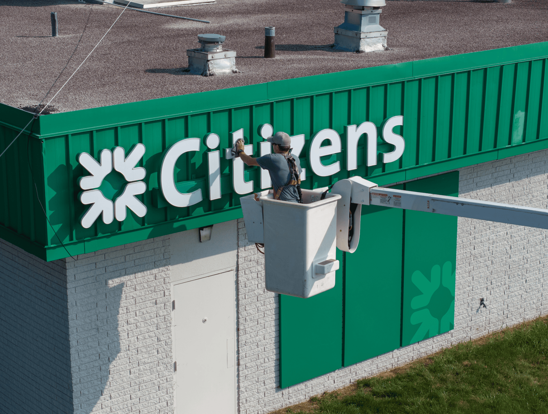 Exterior bank signage being cleaned