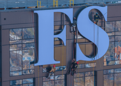 PSCO Sign Group high rise signage installation showcasing engineering, precision fabrication, and turnkey brand execution on a prominent building.