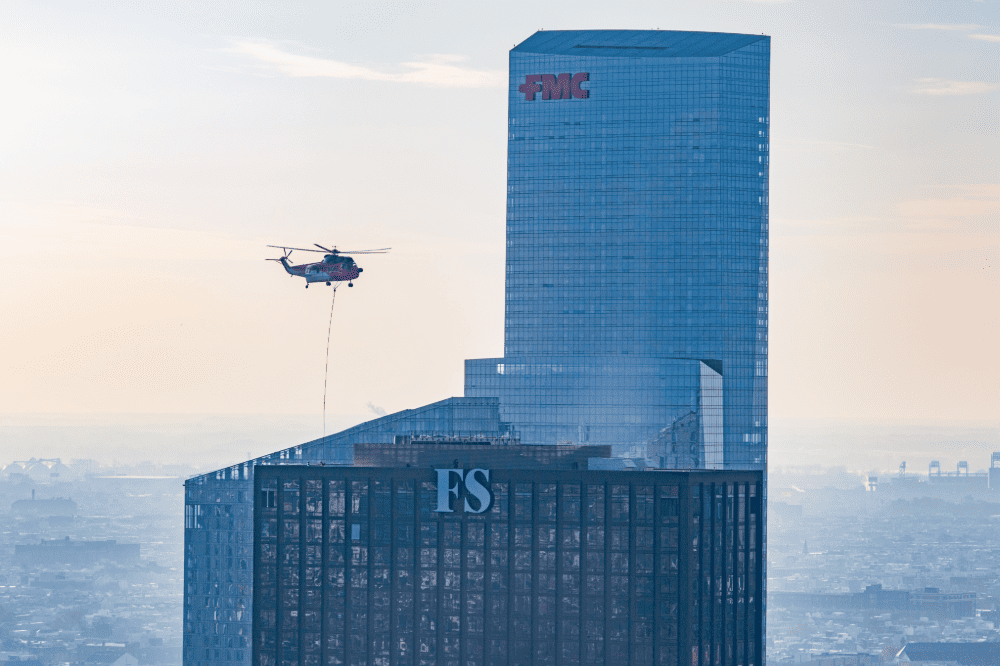 Aerial lift supporting high-rise exterior sign installation