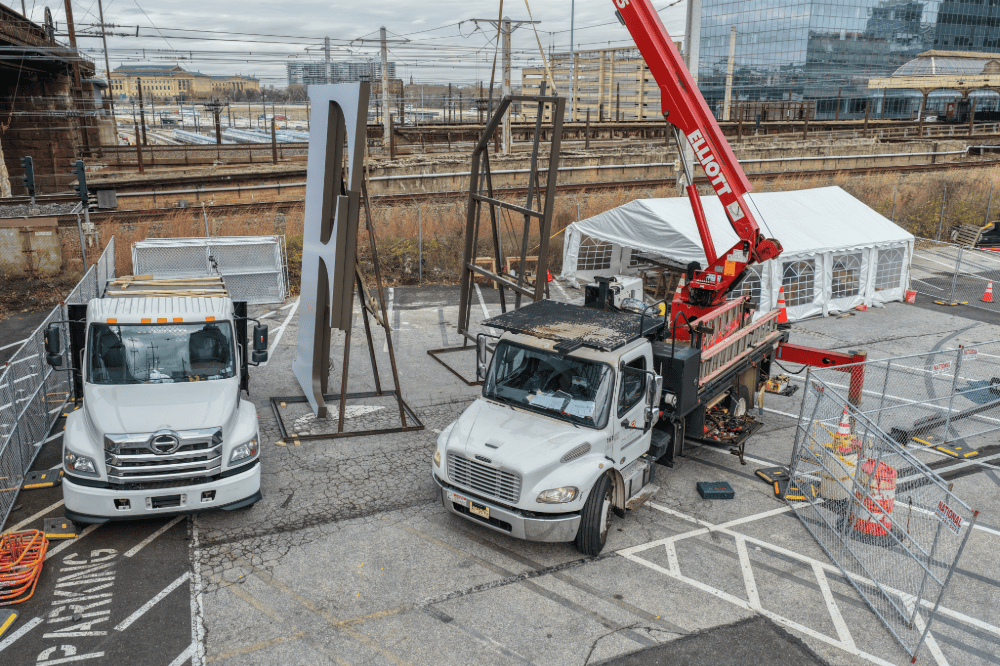Sign installation crew positioning exterior signage on the Future Standard project